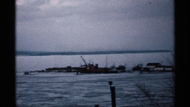 A Factory Construction Site Beside a Village at Open Land with Bare Trees