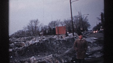 1971: a caucasian person walking through melted ice and snow WISCONSIN