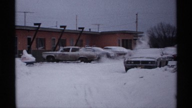 1971: its full of snow and a house also there some cars also parking at the