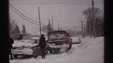 1971: people investigating a car accident during a massive snow storm. WISCONSIN