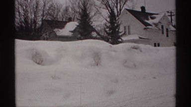 1971: two to three houses located at the snow whether at the morning time with