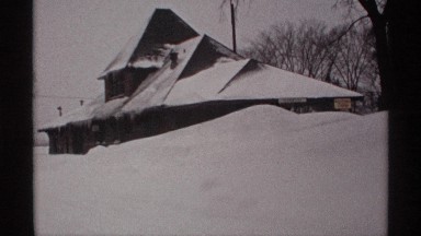 1971: a small hunt that located alone at the snow place and men are walking