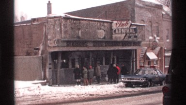 1971: a few people stand outside of an abandoned store that's no longer open