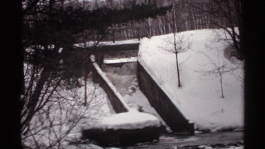 1971: snow covered stairs leading to a stream. WISCONSIN