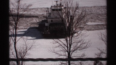 1971: ship turns in circular motion through muddy water between ice sheets