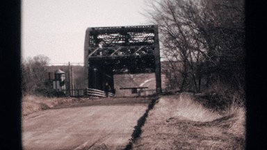 1971: a long road and a small water dam and it looks like so calm at the alone