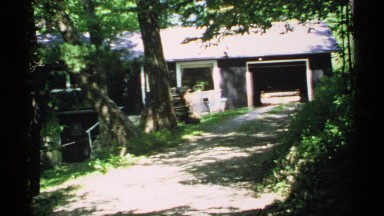 1970: shady pavilion has stone railing and house has car parked in garage