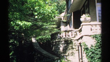 1970: curved stone staircase leads to upper terrace around corner of house