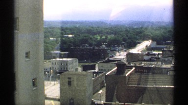 1970: a city with buildings of different sizes and floors build next to a