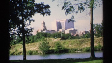 1970: trees and a small river there and a long short the city building also
