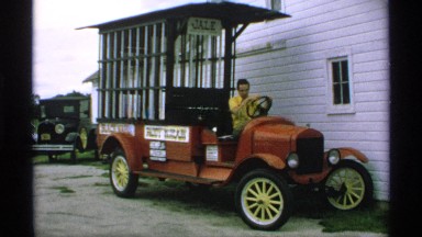 1970: man moves from behind paddy wagon wheel and takes large step down
