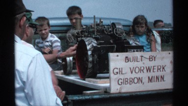 1971: people are watching machine for doing something and a board that also