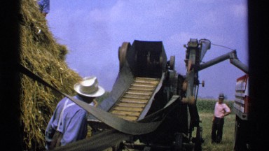 1971: some people watching how a machine to make bales of hay works MINNESOTA
