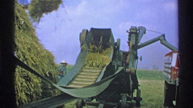 1971: men work in hay field to bundle straw MINNESOTA