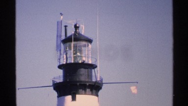 1972: view of the top of a lighthouse with bird flying by ISLE ROYALE MICHIGAN