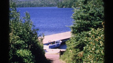 1972: boat parked by the dock on a beautiful day. ISLE ROYALE MICHIGAN