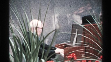 1972: elderly man playing piano outside ISLE ROYALE MICHIGAN