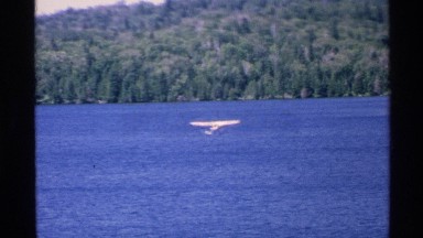 1972: an airplane flying over water. ISLE ROYALE MICHIGAN