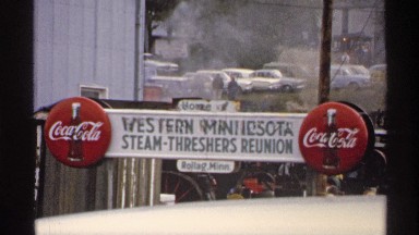 1971: sign announcing steam-threshers reunion is between two coca-cola ads
