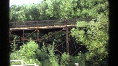 1971: an old, rusted railroad bridge surrounded by forest ROLLAG MINNESOTA