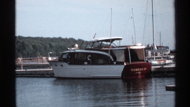 1971: a boat on the water that parked near to the bridge on the water and some