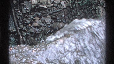 1972: water flows over sharp edge toward gravel and moves along lower levels