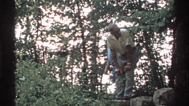 1972: a boy with an elder is motioning someone to go away ISLE ROYALE MICHIGAN