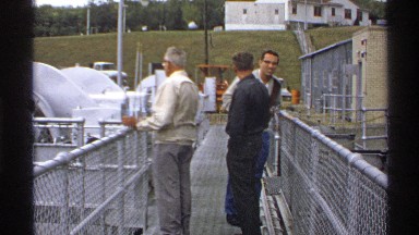 1972: three men discussing something on a narrow bridge. NORTH DAKOTA