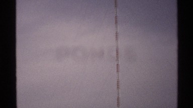 1972: a long stick it looks like a pillar with two colors and the sky and plants