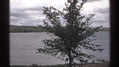 1972: trees in a park alongside a lake with a jetty NORTH DAKOTA