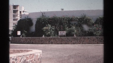1975: Small Sign by Walls Says Office and Points Left to Building Complex