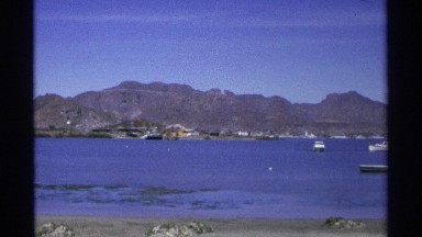 1975: beautiful lake with awesome background of mountain,boat are there to