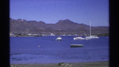 1975: boats are moving at the water looks like a long river and located near to