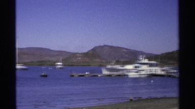 1975: a river with full of water and some boats are moving on that water and the