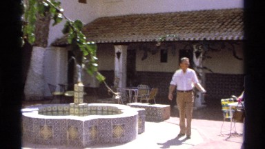 1975: couple walking to sit down at a outdoor restaurant. GUAYMAS MEXICO