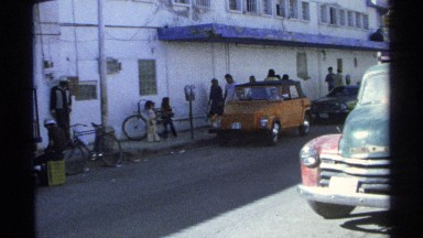1975: yellow car signals to get inside the main road of a small one way street