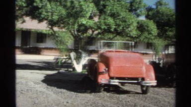 1975: Man with Bag Walking to Automobile in Guaymas Mexico