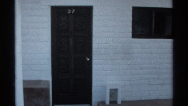 1975: man exiting his home and smiling GUAYMAS MEXICO