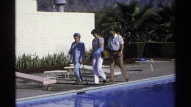 1975: people walking along a poolside. GUAYMAS MEXICO