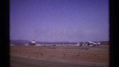 1974: row of airplanes divides the blue sky from the flat airport ground LA PAZ