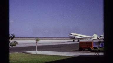 1974: a flight landing at the ground alone and some objects near to the flight