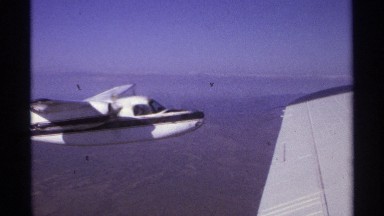 1974: a white airplane in its flight. LA PAZ MEXICO