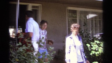 1974: Group of women in pantsuits exiting building in La Paz, Mexico