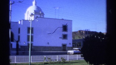 1975: domes and buildings with a mountainous backdrop in the summer GUAYMAS