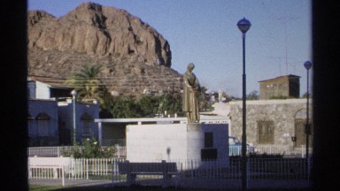1975: a statue located on the wall and a rock with good nature surrounding there