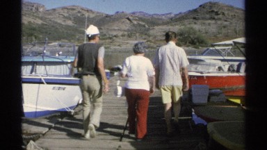 1975: people are walking on the dock to enter to their personal boat, a daytime
