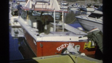 1975: one red speed boat sitting idly among a number of white boats GUAYMAS