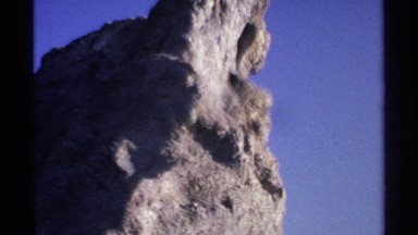 1975: a rock that looks big size and looks like an art and water under the rock