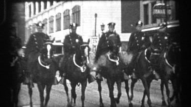 1937: line of mounted police ride horses exhaling vapor in city parade CLEVELAND