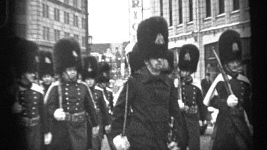 1937: people are walking with a tool at the road they looks like army people and